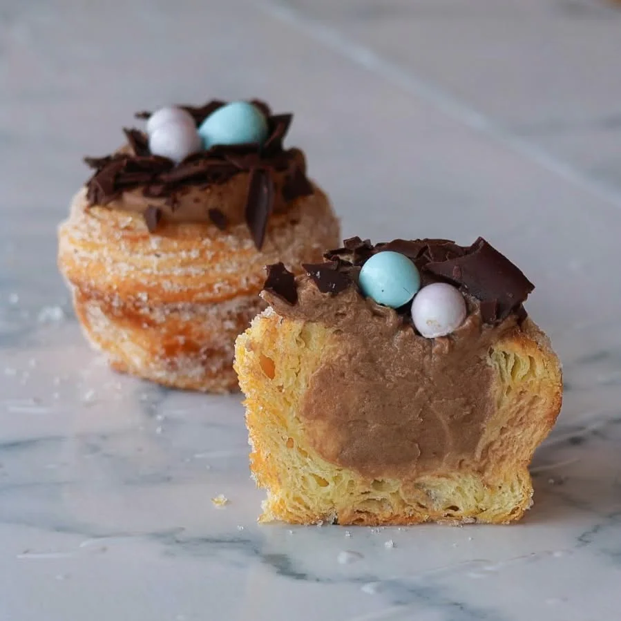 Sugared cruffins filled with chocolate cream, topped with chocolate shards and candy eggs