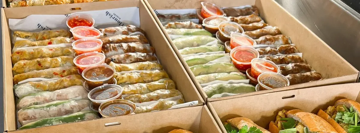 Boxed rice paper rolls with chilli and peanut dipping sauces